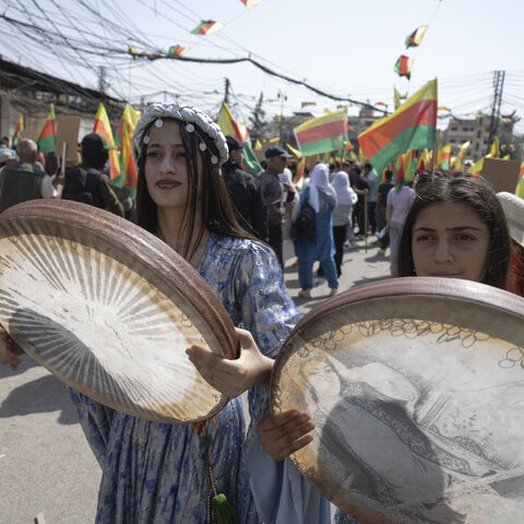 Youths play the daf, an Iranian frame drum, during a protest demanding the right to education in the Kurdish language in Al-Qamishli, Syria, on September 22, 2026. The demonstrations follow a decision by the Syrian Interim Government to allocate only Kurdish language classes in schools. (Photo by Amjad Kurdo / Middle East Images / AFP via Getty Images)