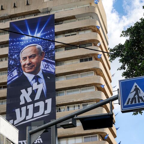 A giant electoral poster for Israeli Prime Minister Benjamin Netanyahu's Likud party with the slogan "no surrender" is displayed on the facade of a building in Tel Aviv on Sept. 29, 2026
