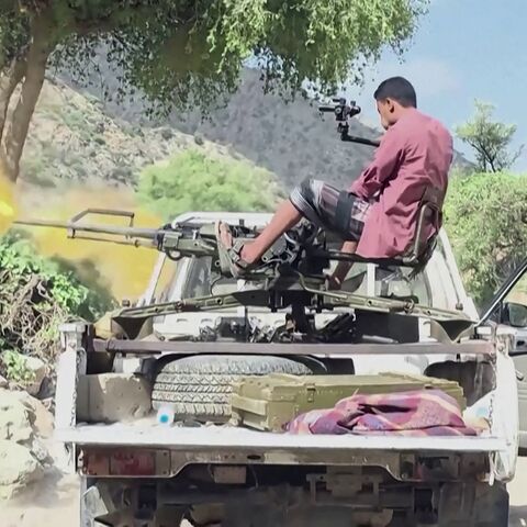a member of the Saudi-backed Yemeni government forces firing a machine gun mounted on a pick-up truck