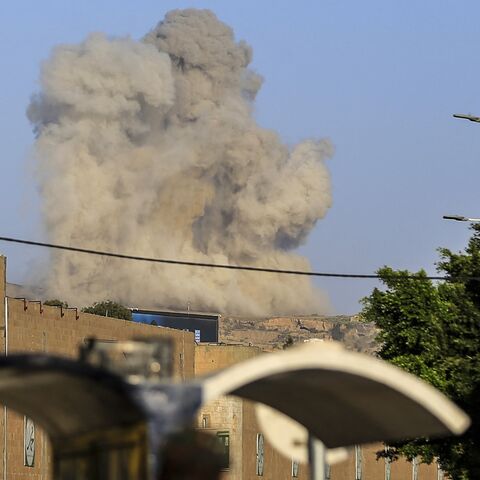 A plume of smoke rises during a reported airstrike by the Saudi-led coalition on the Houthi-controlled Yemeni capital, Sanaa, on Oct. 9, 2026. 
