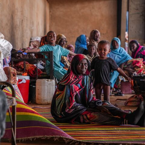 Displaced families sit together on mats and bedding inside a communal shelter in Al-Ubayyid, North Kordofan, Sudan, on March 30, 2026. 