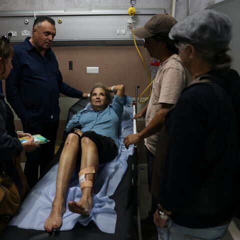 American freelance photojournalist Heidi Levine lies on a gurney in the emergency room of the government hospital in the Israeli-occupied city of Ramallah, as she is treated after being attacked by Israeli settlers while photographing Palestinian farmers harvesting their olives, in the Palestinian village of Abu Falah on Oct. 16, 2026.
