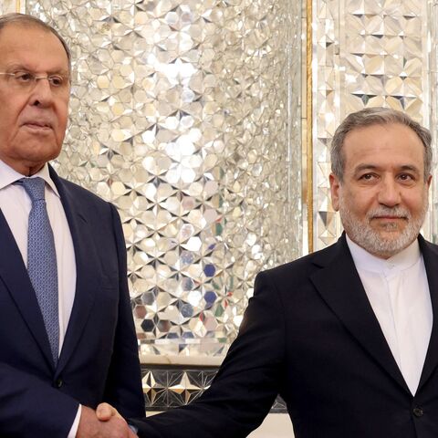 Russian Foreign Minister Sergey Lavrov (L) shakes hands with Iranian Foreign Minister Abbas Araghchi upon his arrival in Tehran on Oct. 19, 2026. 