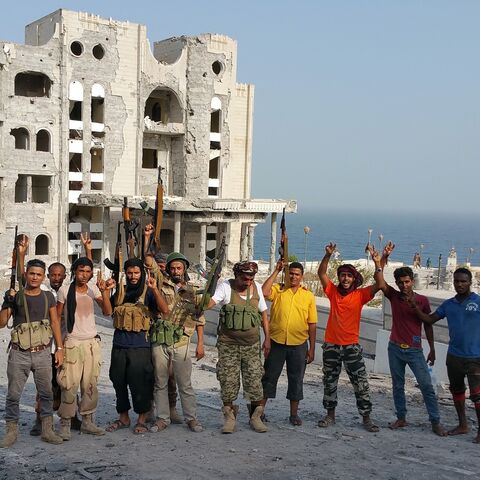 Fighters loyal to Yemen's exiled President Abedrabbo Mansour Hadi pose for a picture near the presidential palace (unseen R) following clashes in Aden's Maashiq neighborhood on July 22, 2015. 