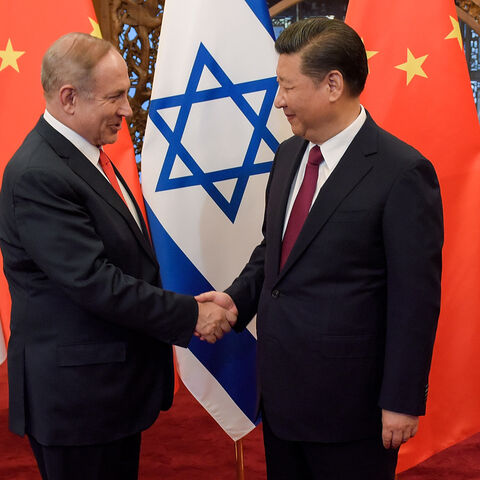China's President Xi Jinping (R) and Israel's Prime Minister Benjamin Netanyahu shake hands ahead of their talks at Diaoyutai State Guesthouse in Beijing on March 21, 2017.