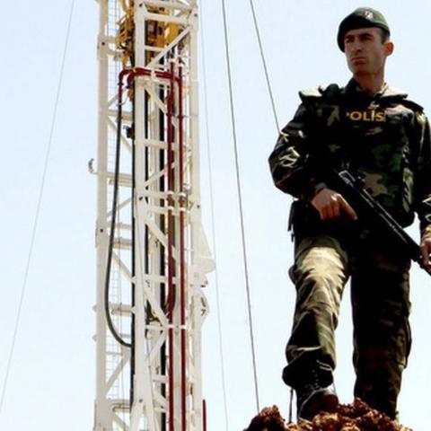 A Turkish police officer stands guard close to a drilling rig near Famagusta April 26, 2012. Turkey on Thursday began drilling for oil and gas in breakaway northern Cyprus, threatening to inflame tensions with Greek Cypriots and undermine UN-backed efforts to reunite the divided island, key to Ankara's aspirations to join the European Union. At a ceremony in northeast Cyprus, the state-run Turkish Petroleum Corporation (TPAO) launched onshore drilling at the 3,000-metre-deep Turkyurdu-1 well in search of hy