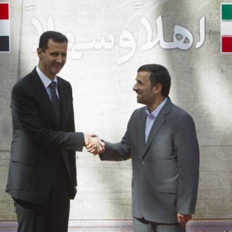 EDITORS' NOTE: Reuters and other foreign media are subject to Iranian restrictions on their ability to report, film or take pictures in Tehran. 

Iranian President Mahmoud Ahmadinejad (R) shakes hands with his Syrian counterpart Bashar al-Assad during an official welcoming ceremony in Tehran October 2, 2010. REUTERS/Morteza Nikoubazl (IRAN - Tags: POLITICS) - RTXSXO5
