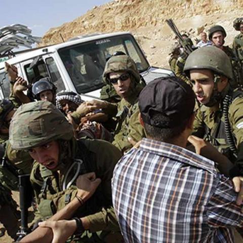 Israeli soldiers scuffle with Palestinians near a truck loaded with items European diplomats wanted to deliver to locals in the West Bank herding community of Khirbet al-Makhul, in the Jordan Valley September 20, 2013. Israeli soldiers manhandled European diplomats on Friday and seized a truck full of tents and emergency aid they had been trying to deliver to Palestinians whose homes were demolished earlier this week. REUTERS/Abed Omar Qusini (WEST BANK - Tags: POLITICS CIVIL UNREST MILITARY) - RTX13SGZ