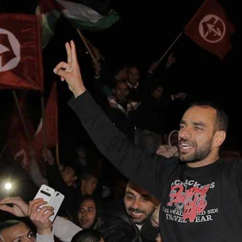 Released Palestinian prisoner Samer al-Issawi gestures as he celebrates in the East Jerusalem neighbourhood of Issawiya December 23, 2013. Israel on Monday freed al-Issawi from jail, to complete a deal agreed earlier this year over his release in exchange for him ending a lengthy hunger strike that almost killed him. REUTERS/Ammar Awad (JERUSALEM - Tags: POLITICS CIVIL UNREST) - RTX16SOH