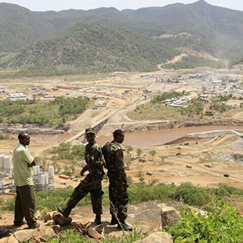 Security guards look at the construction of Ethiopia's Great Renaissance Dam in Guba Woreda, some 40 km (25 miles) from Ethiopia's border with Sudan, June 28, 2013. Egypt fears the $4.7 billion dam, that the Horn of Africa nation is building on the Nile, will reduce a water supply vital for its 84 million people, who mostly live in the Nile valley and delta. Picture taken June 28, 2013. REUTERS/Tiksa Negeri (ETHIOPIA - Tags: POLITICS SOCIETY ENERGY ENVIRONMENT) - RTX115K8