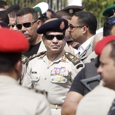 Army Chief General Abdel Fattah al-Sisi (C) attends the military funeral service of Police General Nabil Farag, who was killed on Thursday in Kerdasa, at Al-Rashdan Mosque in Cairo's Nasr City district September 20, 2013. Egyptian security forces were hunting for supporters of deposed President Mohamed Mursi of the Muslim Brotherhood on Friday after retaking control of a town near Cairo in a crackdown on Islamists. On Thursday, army and police forces stormed Kerdasa where Islamist sympathies run deep and ho