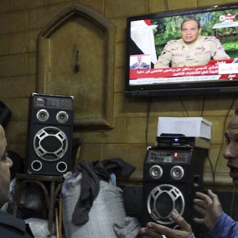 People listen to the speech by Egypt's army chief Field Marshal Abdel Fattah al-Sisi declaring his candidacy for a presidential election, in a public cafe in Cairo March 26, 2014. Al-Sisi, the general who ousted Egypt's first freely elected leader, on Wednesday declared his candidacy for a presidential election he is expected to win easily. REUTERS/Al Youm Al Saabi Newspaper (EGYPT - Tags: POLITICS MILITARY ELECTIONS) EGYPT OUT. NO COMMERCIAL OR EDITORIAL SALES IN EGYPT - RTR3IQSF