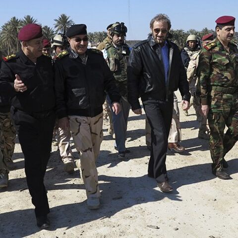 Iraqi acting Defence Minister Saadoun al-Dulaimi (3rd R) walks with army officers during the tour in Anbar province, February 7, 2014.  ISIL militants and other Sunni groups angered by the Shi'ite-led government overran Falluja and parts of the nearby city of Ramadi in the western province of Anbar on Jan. 1. REUTERS/Stringer (IRAQ - Tags: CIVIL UNREST MILITARY) - RTX18DJ1