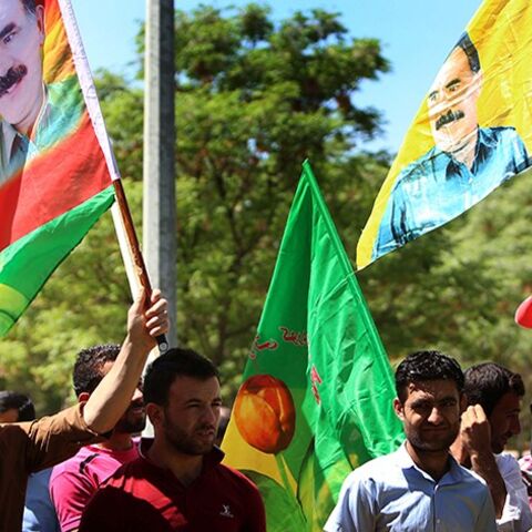 Iraqi Kurdish supporters of the Kurdistan Workers Party (PKK) hold flags bearing portraits of jailed PKK leader Abdullah Ocalan during a demonstration in Arbil on April 12, 2014 against the decision by Kurdish authorities to dig a trench along the border with neighboring Syria. The Kurdish autonomous region has backed Kurds in Syria against the extremists and has taken in some 200,000 refugees from the bloody conflict. AFP PHOTO / SAFIN HAMED        (Photo credit should read SAFIN HAMED/AFP/Getty Images)