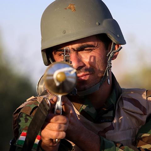 An Iraqi Kurdish Peshmerga fighter poses for a picture on the front line in Makhmur, about 280 kilometres (175 miles) north of the capital Baghdad, during clashes with Islamic State (IS) militants on August 9, 2014. Makhmur, is one of the areas that had been attacked by jihadist fighters in recent days. AFP PHOTO/SAFIN HAMED        (Photo credit should read SAFIN HAMED/AFP/Getty Images)