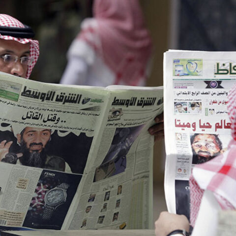 People read the newspapers with cover stories of Osama bin Laden, in Riyadh, May 3, 2011. Bin Laden was killed in a U.S. special forces assault on a Pakistani compound, then quickly buried at sea, in a dramatic end to the long manhunt for the al Qaeda leader who had been the guiding star of global terrorism. REUTERS/Mohammed Mashhor    (SAUDI ARABIA - Tags: SOCIETY MEDIA) - RTR2LXUQ