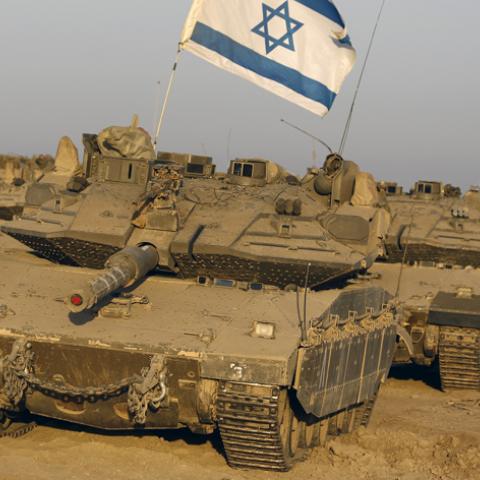 Israeli tanks are seen in a staging area near the border with the Gaza Strip August 7, 2014. Mediators worked against the clock on Thursday to extend a Gaza truce between Israel and the Palestinians as the three-day ceasefire went into its final 24 hours. Israel has said it is ready to agree to an extension as Egyptian mediators pursued talks with Israelis and Palestinians on an enduring end to a war that devastated the Hamas-ruled enclave, while Palestinians want an Israeli-Egyptian blockade of Gaza to be 