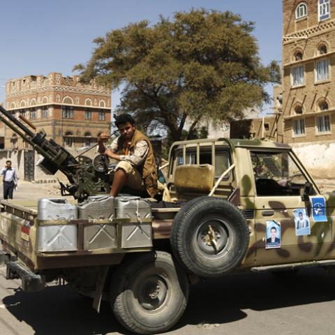 A follower of the Shi'ite Houthi movement mans a machine gun mounted on a military pick up in Sanaa October 20, 2014. The truck was taken by the movement's fighters during recent clashes with army soldiers in Sanaa. REUTERS/Khaled Abdullah (YEMEN - Tags: POLITICS CIVIL UNREST MILITARY) - RTR4AU1L