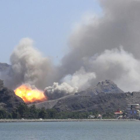 An arms depot explodes at the Jabal Hadeed military compound in Yemen's southern port city of Aden March 28, 2015. Explosions rocked Aden's largest arms depot on Saturday, sending flames and smoke into the sky above the southern Yemeni city, witnesses said. A Reuters correspondent saw fire and explosions at the Jabal Hadeed compound, which is close to residential and commercial properties. There was no immediate word of casualties. REUTERS/Nabeel Quaiti      TPX IMAGES OF THE DAY      - RTR4V93W