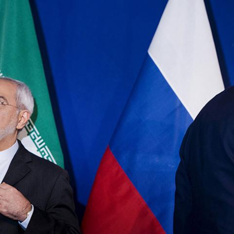 Iranian Foreign Minister Javad Zarif (L) waits to make a statement next to U.S. Secretary of State John Kerry (R), following nuclear talks at the Swiss Federal Institute of Technology in Lausanne (Ecole Polytechnique Federale De Lausanne) April 2, 2015. Iran and world powers reached a framework on curbing Iran's nuclear programme at marathon talks in Switzerland on Thursday that will allow further negotiations towards a final agreement. REUTERS/Brendan Smialowski/Pool - RTR4VXHZ