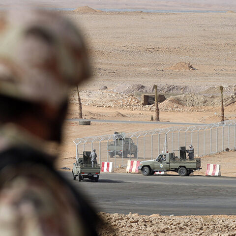 A member of the Saudi security forces stands guard as other demonstrate their skills during a military exercise in Arar, near Saudi Arabia's northern border with Iraq March 18, 2015. REUTERS/Faisal AlNasser (SAUDI ARABIA - Tags: MILITARY POLITICS) - RTR4TWNJ