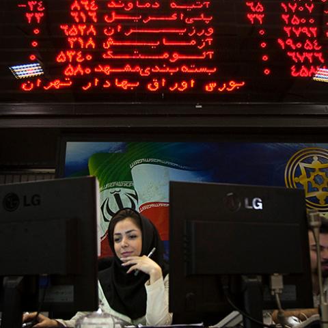 EDITORS' NOTE:  Reuters and other foreign media are subject to Iranian restrictions on their ability to film or take pictures in Tehran.

An Iranian official works at her desk in the main hall of the Tehran Stock Exchange August 3, 2010. Sanctions against Iran have done nothing to dent a boom in its stock market, as investors bet on a continued rise in company stocks which have been undervalued for years, the head of the Tehran bourse said.    REUTERS/Morteza Nikoubazl (IRAN - Tags: BUSINESS POLITICS) - RTR