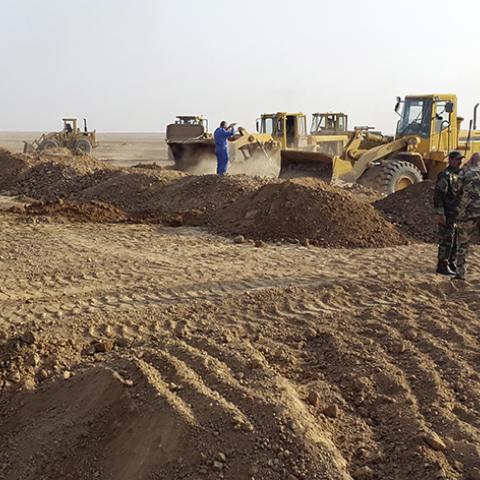People operate heavy machinery during the building of a new road between Diyala province and Samarra December 21, 2014.  A Shi'ite paramilitary organization is constructing a road to strengthen its positions across the mixed areas of Diyala and neighbouring Salahuddin province. The Badr Organization, a leading political party and militia with ties to Iran, is supervising the new road, which leads to Samarra. It means Badr can resupply troops guarding Samarra, currently surrounded by Islamic State, and the 3