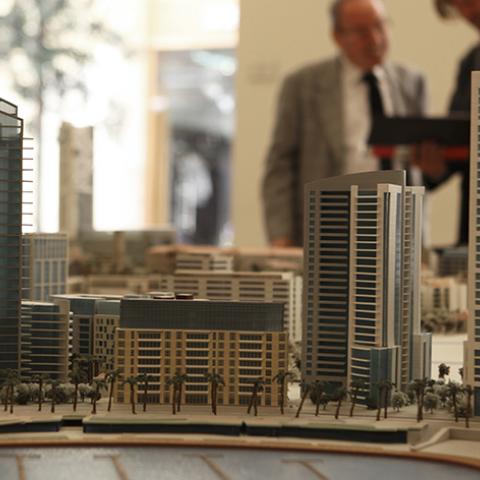 An employee for Lebanon's biggest company and real estate firm, Solidere, shows a journalist a model of Beirut's Solidere development at their office in Beirut, September 25, 2009. Shares in Lebanese real estate firm Solidere rallied for a second day on Friday, boosted by expectations of progress towards the formation of a new goverment, traders said. REUTERS/Jamal Saidi   (LEBANON BUSINESS) - RTR289D6