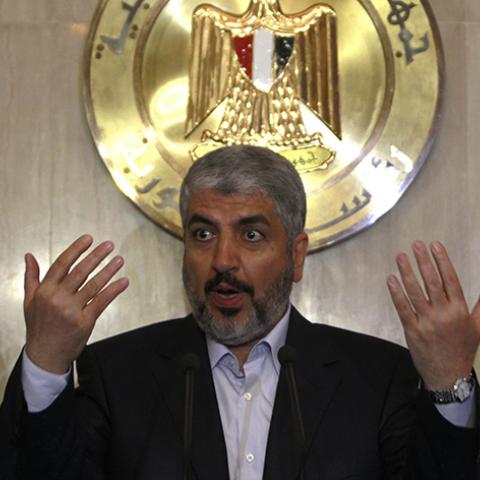 Hamas leader Khaled Meshaal (C) speaks during a news conference with Hamas delegates after their meeting with Egypt's President Mohamed Mursi at the presidential palace in Cairo July 19, 2012. REUTERS/Amr Abdallah Dalsh  (EGYPT - Tags: POLITICS) - RTR352XW