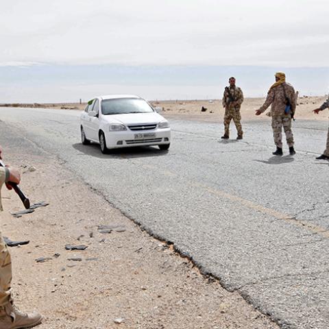 Libyan soldiers manning a military outpost, stop a car at a checkpoint in Wadi Bey, west of the city of Sirte, which is held by Islamic State militants, February 23, 2016. REUTERS/Ismail Zitouny - RTX28A55