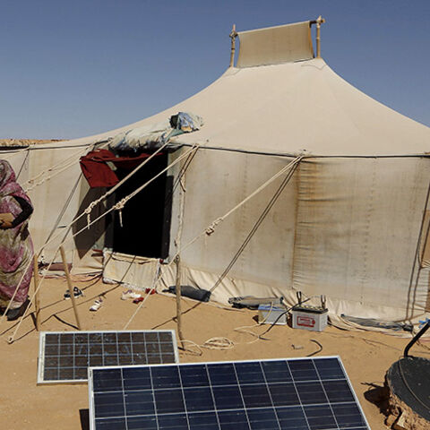 An indigenous Sahrawi woman walks outside her tent in Al Smara desert refugee camp in Tindouf, southern Algeria March 4, 2016. In refugee camps near the town of Tindouf in arid southern Algeria, conditions are hard for indigenous Sahrawi residents. Residents use car batteries for electricity at night and depend on humanitarian aid to get by. The five camps near Tindouf are home to an estimated 165,000 Sahrawi refugees from the disputed region of Western Sahara, according to the United Nations refugee agency