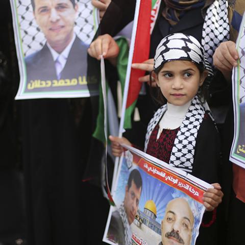 Palestinian supporters of former head of Fatah in Gaza, Mohammed Dahlan, hold posters depicting Dahlan (R) during a protest against Palestinian President Mahmoud Abbas in Gaza City December 18, 2014. Dahlan, who lives in exile in the Gulf, is a powerful political foe of Abbas. 
REUTERS/Mohammed Salem (GAZA - Tags: POLITICS CIVIL UNREST) - RTR4IJ93