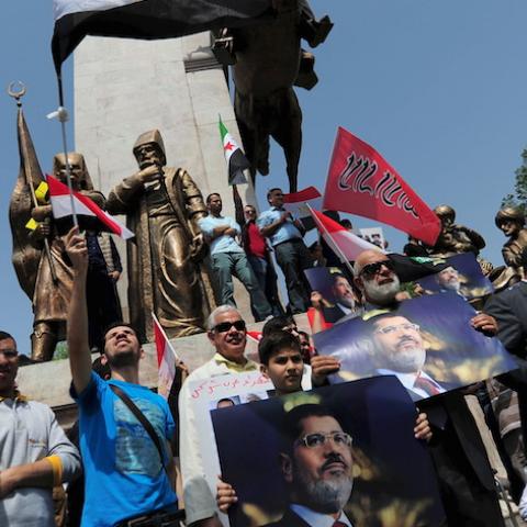 Pro-Islamist demonstrators hold Egyptian flags and posters of former President Mohamed Mursi during a protest in support of him at the courtyard of Fatih mosque in Istanbul, Turkey, May 17, 2015. An Egyptian court on Saturday sought the death penalty for former president Mohamed Mursi and 106 supporters of his Muslim Brotherhood in connection with a mass jail break in 2011. Mursi and his fellow defendants, including top Brotherhood leader Mohamed Badie, were convicted for killing and kidnapping policemen, a