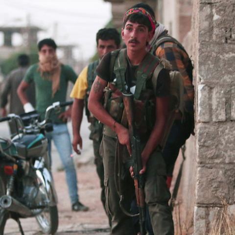 Kurdish fighters from the People's Protection Units (YPG) carry their weapons as they take positions in the northeastern city of Hasaka, Syria, August 20, 2016. Picture taken August 20, 2016. REUTERS/Rodi Said     TPX IMAGES OF THE DAY      - RTX2MEE9