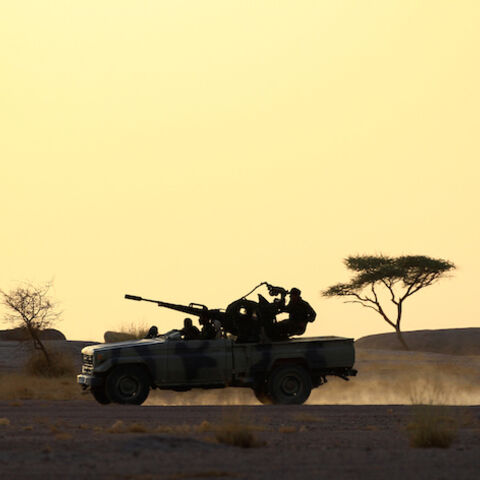 The Polisario Front soldiers drive a pick-up truck mounted with an anti-aircraft weapon during sunset in Bir Lahlou, Western Sahara, September 9, 2016. REUTERS/Zohra Bensemra          SEARCH ìPOLISARIOî FOR THIS STORY. SEARCH "WIDER IMAGE" FOR ALL STORIES.     - RTX2RO75