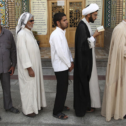 Men stand in line to vote during the Iranian presidential election at a mosque in Qom, 120 km (74.6 miles) south of Tehran June 14, 2013. Millions of Iranians voted to choose a new president on Friday, urged by Supreme Leader Ayatollah Ali Khamenei to turn out in force to discredit suggestions by arch foe the United States that the election would be unfair. REUTERS/Fars News/Mohammad Akhlagi  (IRAN - Tags: POLITICS ELECTIONS) ATTENTION EDITORS - THIS IMAGE WAS PROVIDED BY A THIRD PARTY. FOR EDITORIAL USE ON
