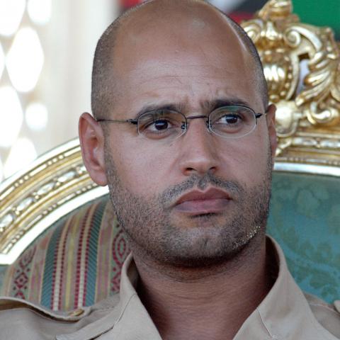 The son of Libyan leader Moamer Kadhafi Saif al-Islam (R) sits with Libyan Prime Minister Baghdadi Mahmudi (not seen) as they attend a ceremony to mark the arrival of water from the Great Manmade River (GMR) in the southern Libyan city of Ghiryan, 18 August 2007. The Great Manmade River is a huge network of pipes supplying water from under the Sahara desert to various cities and population centres in Libya. AFP PHOTO/ MAHMUD TURKIA (Photo credit should read MAHMUD TURKIA/AFP/Getty Images)