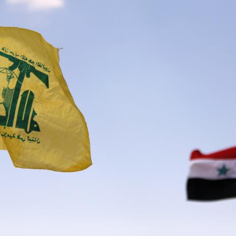 Hezbollah and Syrian flags are seen fluttering in Fleita, Syria August 2, 2017. REUTERS/ Omar Sanadiki - RC15E3E7FA20
