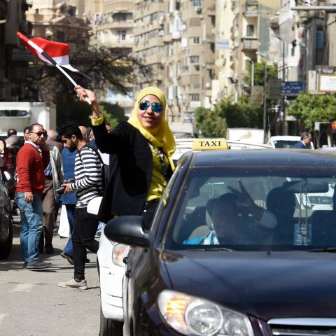 An Egyptian woman waves her national flag out of the window of a taxi on the first day of voting for the 2018 presidential elections on March 26, 2018.
Egyptians head to the polls in a three-day vote to choose between incumbent Abdel Fattah al-Sisi and little-known candidate Moussa Mostafa Moussa, who has struggled to make the case he is not Sisi's minion. / AFP PHOTO / KHALED DESOUKI        (Photo credit should read KHALED DESOUKI/AFP/Getty Images)