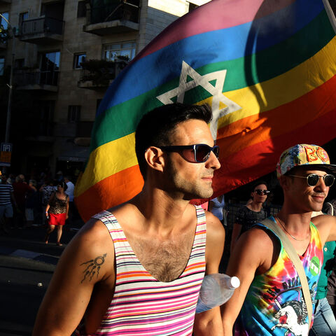 Israelis carry a gay pride rainbow flag with the Star of David during the annual Jerusalem Gay Pride Parade on July 21, 2016.
Israeli police said they suspected the man behind the attack on last year's march, Yishai Shlissel, an ultra-Orthodox Jew who killed a teenager and stabbed five other people, had been in contact with his brother from prison about an assault on the event. / AFP / GALI TIBBON        (Photo credit should read GALI TIBBON/AFP/Getty Images)