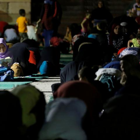 An Egyptian Muslim girl reads the koran during an evening prayers called "Tarawih" on Laylat al-Qadr or Night of Decree, at Amr Ibn El-Aas mosque, the first and oldest mosque ever built on the land of Egypt, during the Muslim holy month of Ramadan in old Cairo, Egypt June 21, 2017. REUTERS/Amr Abdallah Dalsh - RC1ECD154720