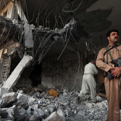Iranian Kurdish Peshmerga members of the Iranian Kurdistan Democratic Party (KDPI) check the damage after a rocket attack inside their headquarters in Koysinjaq, 100 kilometres east of Arbil, the capital of the autonomous Kurdish region of eastern Iraq, on September 8, 2018. - At least a dozen members of the Iranian Kurdish rebel group were killed on September 8 in the a rocket attack on their headquarters carried out by Iran's Revolutionary Guards. The Kurdistan Democratic Party of Iran (KDPI) has carried 