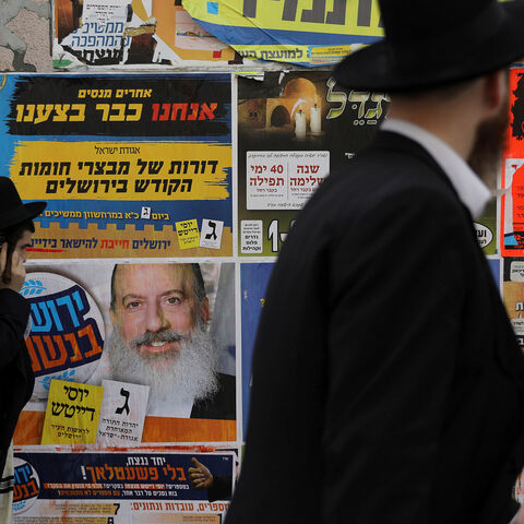 Ultra-Orthodox Jewish men walk past a campaign poster depicting ultra-Orthodox Jewish candidate in Jerusalem's mayoral election Yossi Daitsh, in Jerusalem October 18, 2018. REUTERS/Ammar Awad - RC1A4B7FF670