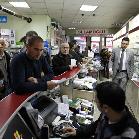 People shop in a pharmacy that did not participate in a  protest in Ankara December 4, 2009. Pharmacies shut down all over Turkey on Friday for one day to protest price discounts on drugs enforced by the government. REUTERS/Umit Bektas (TURKEY POLITICS HEALTH CONFLICT) - GM1E5C41P5H01