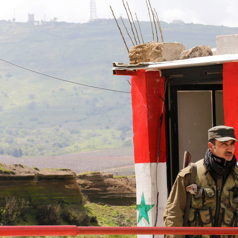 A Syrian army soldier stands at a checkpoint at the Quneitra crossing between the Israeli-controlled Golan Heights and Syria, seen from the Syrian side in Quneitra, Syria March 26, 2019. REUTERS/Omar Sanadiki - RC1B4F2B5A00