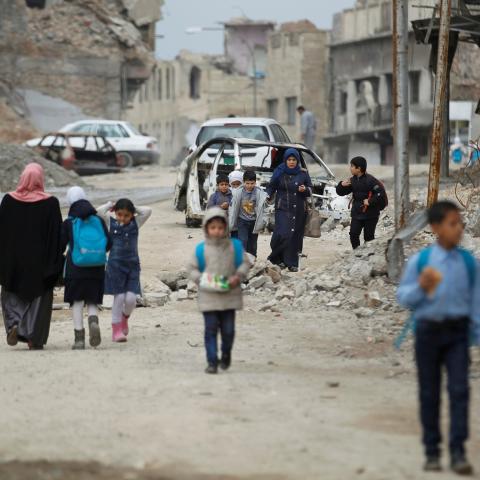 Iraqi school students pass by destroyed buildings by the war, in the Old City of Mosul, Iraq February 27, 2019. REUTERS/Khalid al-Mousily - RC1D1A58CF70