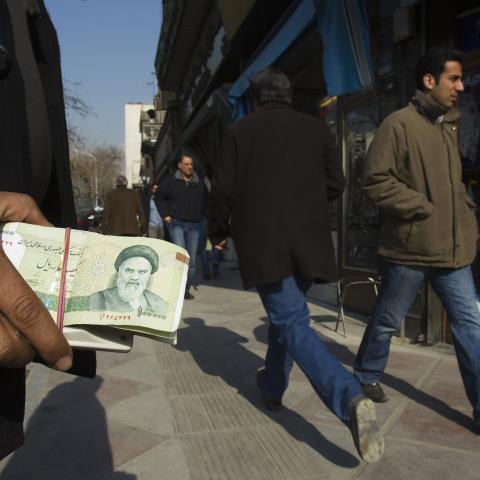 EDITORS' NOTE: Reuters and other foreign media are subject to Iranian restrictions on leaving the office to report, film or take pictures in Tehran.

A money changer holds Iranian rial banknotes as he waits for customers in Tehran's business district January 7, 2012. REUTERS/Raheb Homavandi  (IRAN - Tags: BUSINESS) - GM1E8171GCD01