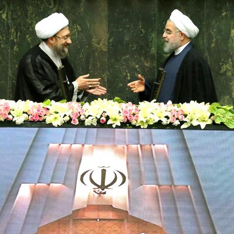 Iranian president Hassan Rouhani extends his hand to Iran's Judiciary Chief Sadegh Larijani during a swearing-in ceremony for Rouhani for a further term, at the parliament in Tehran, Iran, August 5, 2017. Nazanin Tabatabaee Yazdi/TIMA via REUTERS ATTENTION EDITORS - THIS IMAGE WAS PROVIDED BY A THIRD PARTY.     TPX IMAGES OF THE DAY - RC15208A0ED0