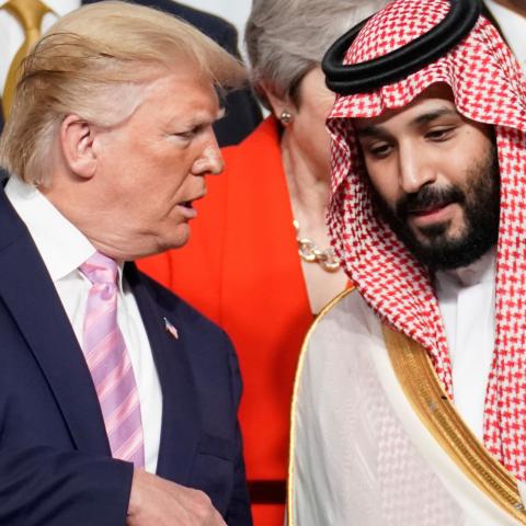 U.S. President Donald Trump speaks with Saudi Arabia's Crown Prince Mohammed bin Salman during family photo session with other leaders and attendees at the G20 leaders summit in Osaka, Japan, June 28, 2019.  REUTERS/Kevin Lamarque - RC187E92FB00