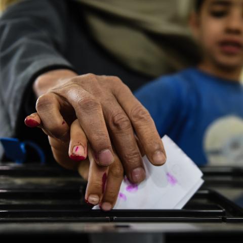 An man Egyptian casts his ballot with a child at a polling station during the third day of a referendum on constitutional amendments, at a school in shamma village in the northern Nile delta province of Menoufia, on April 22, 2019. (Photo by Mohamed el-Shahed / AFP)        (Photo credit should read MOHAMED EL-SHAHED/AFP/Getty Images)